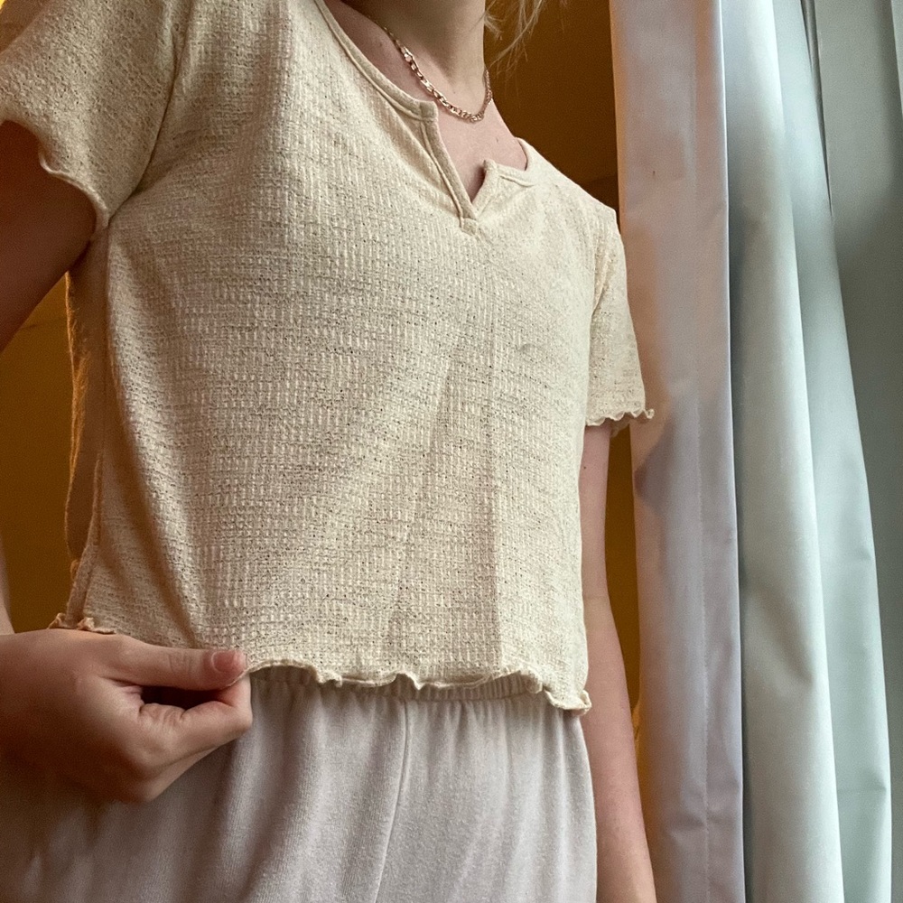 cream colored light weight t shirt with v neckline